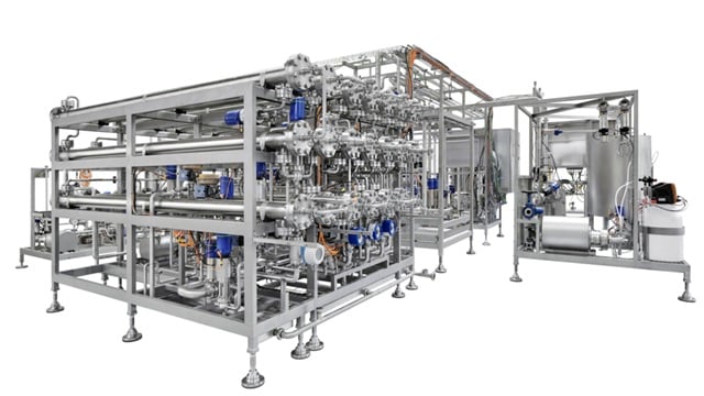  Complex stainless steel industrial processing system with pipes, valves, and tanks for manufacturing or food production.