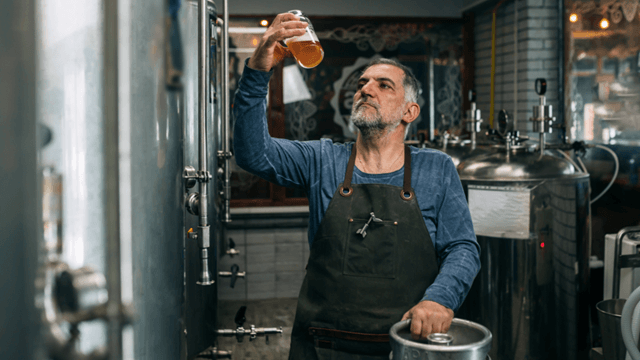 brewery-brewer-inspecting-craft-beer-fermentation-tanks.png